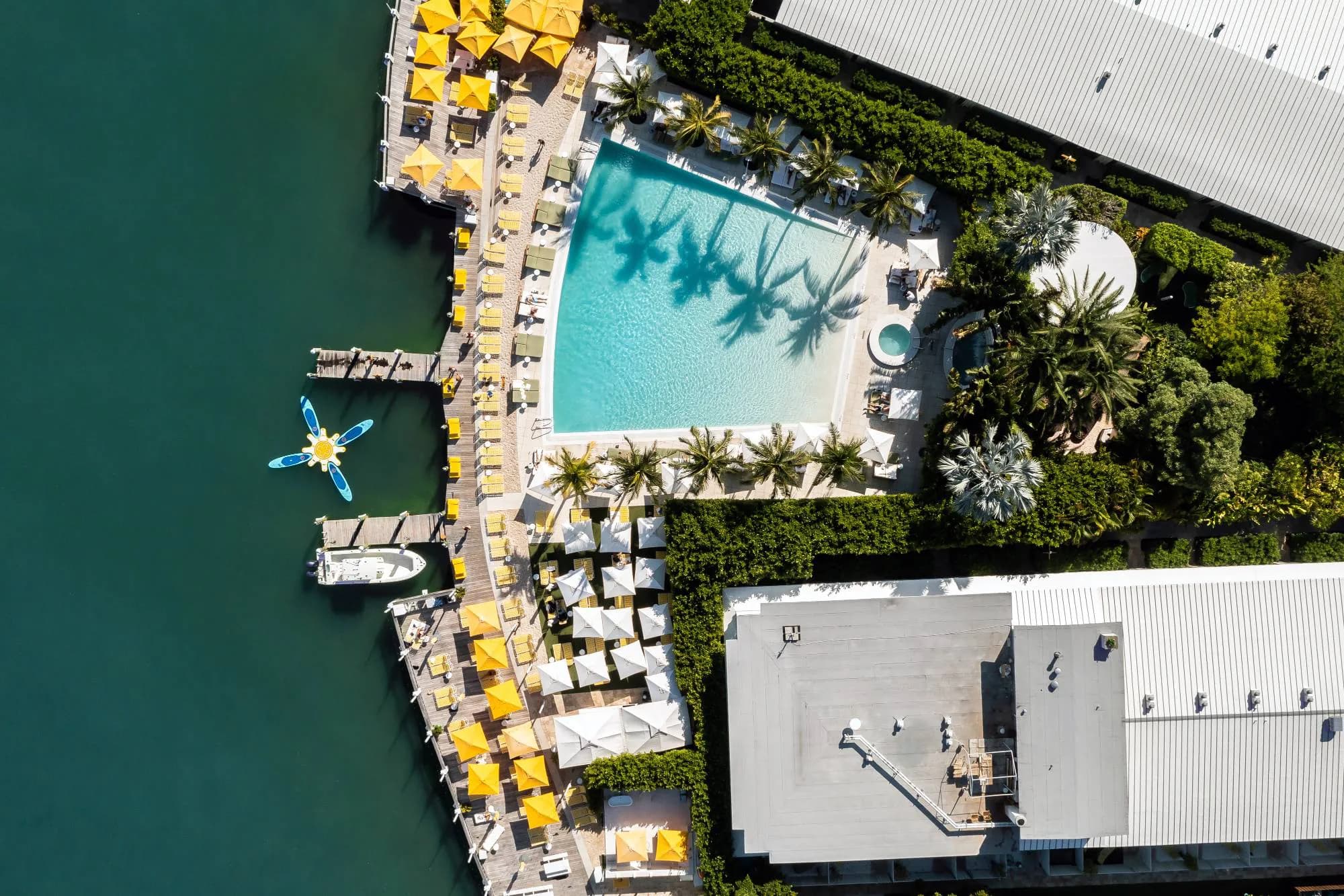 Aerial view of The Standard Spa, Miami Beach — the pool deck and yellow umbrellas on Biscayne Bay